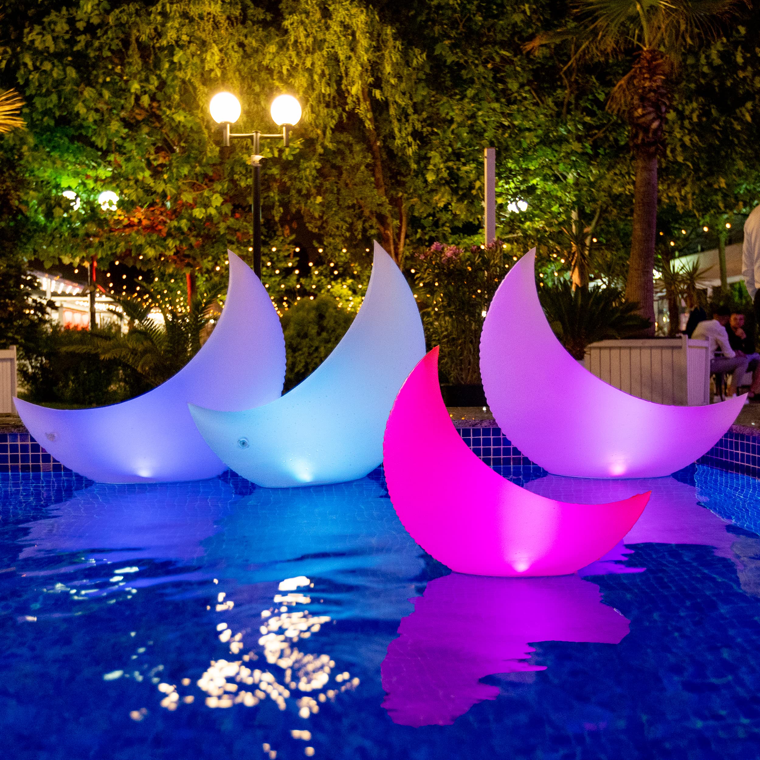 TIALLY front view of four crescent moon pool lights showcasing color options and shape, enhances pool mood