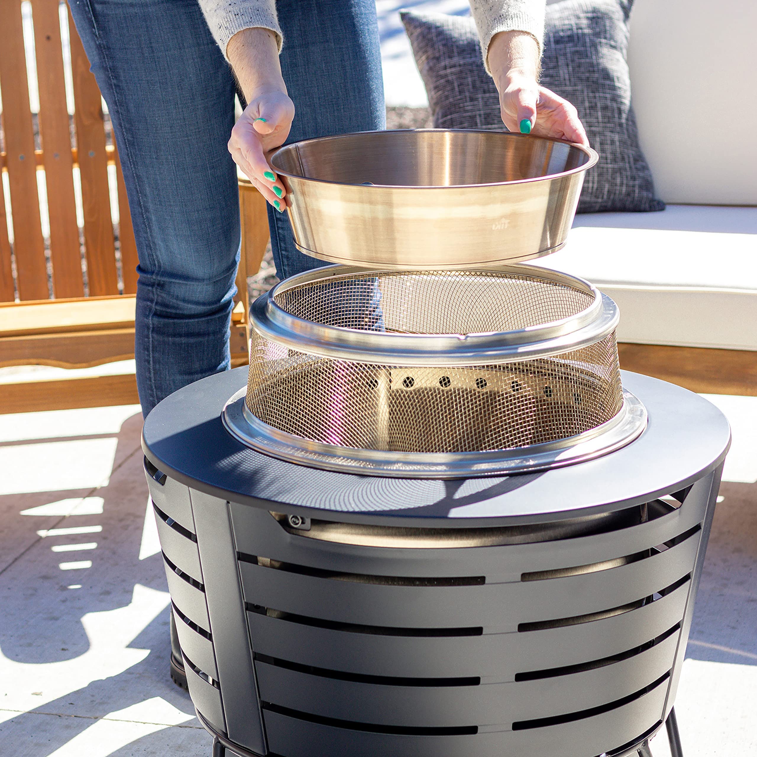 TIKI installed on patio fire pit focusing heat outward, increases radiant warmth