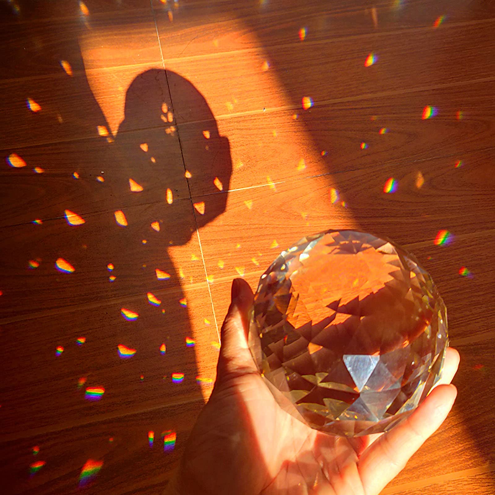 Together-life sphere in window casting rainbow beams across room for ambience
