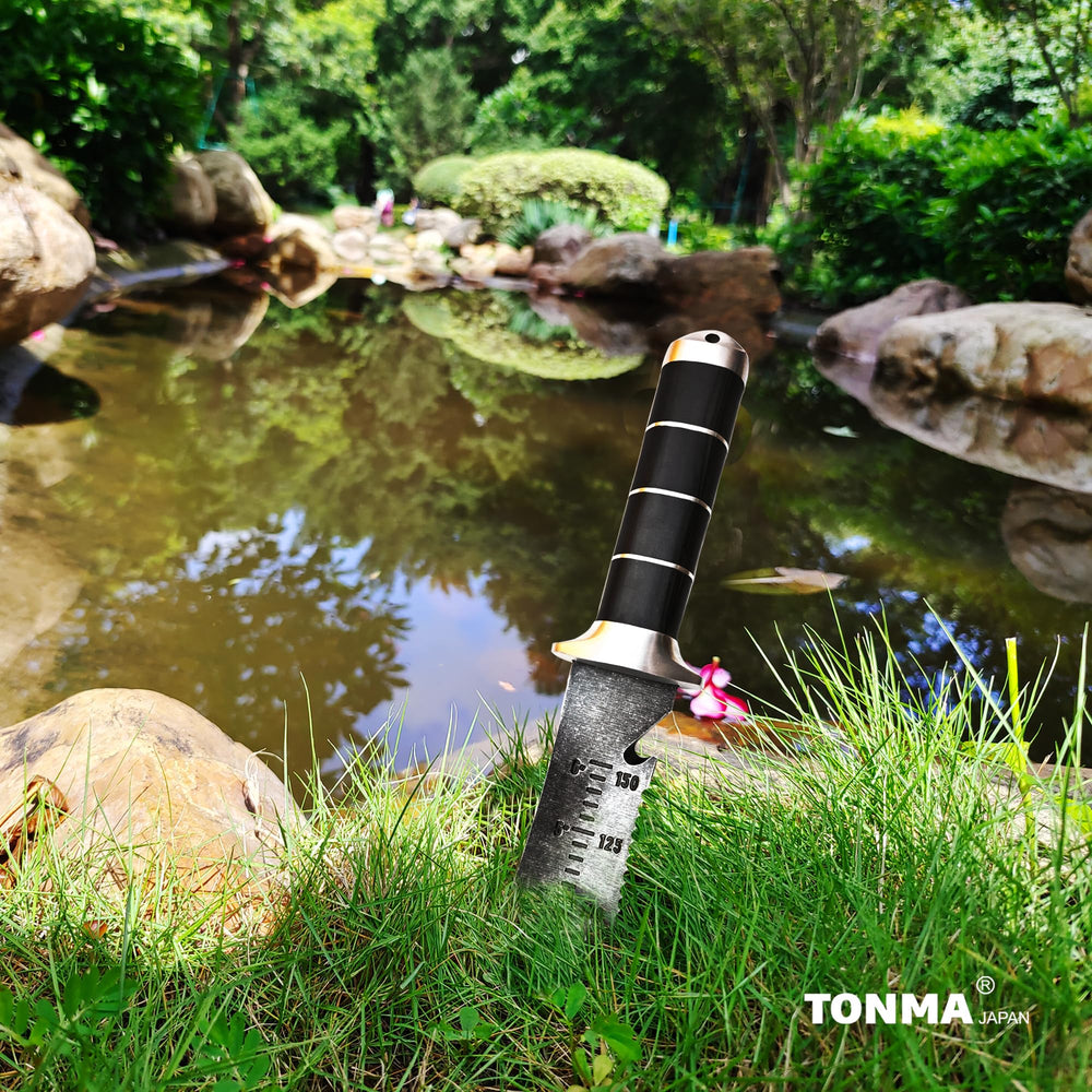 TONMA garden knife in use transplanting bulbs illustrating precise scooping