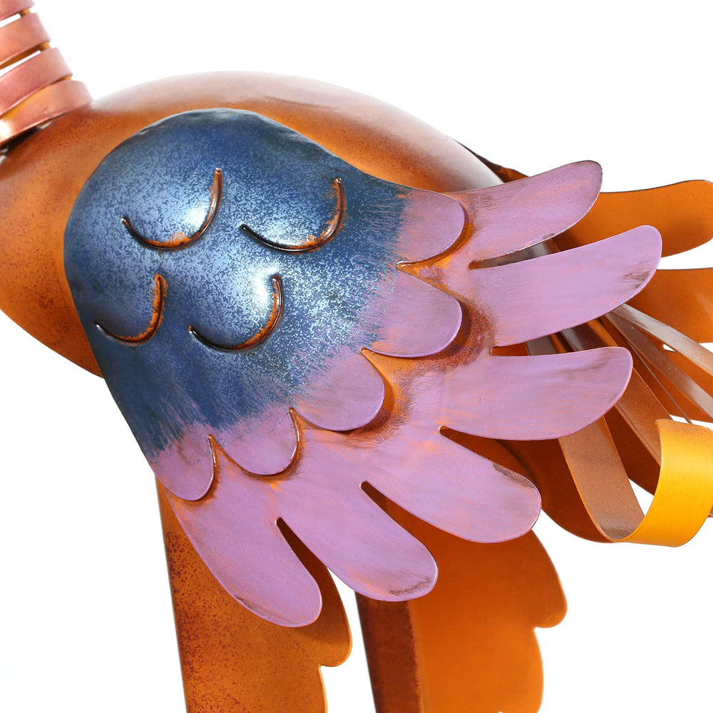 Tooarts toucan placed in flowerbed adding whimsical outdoor focal point