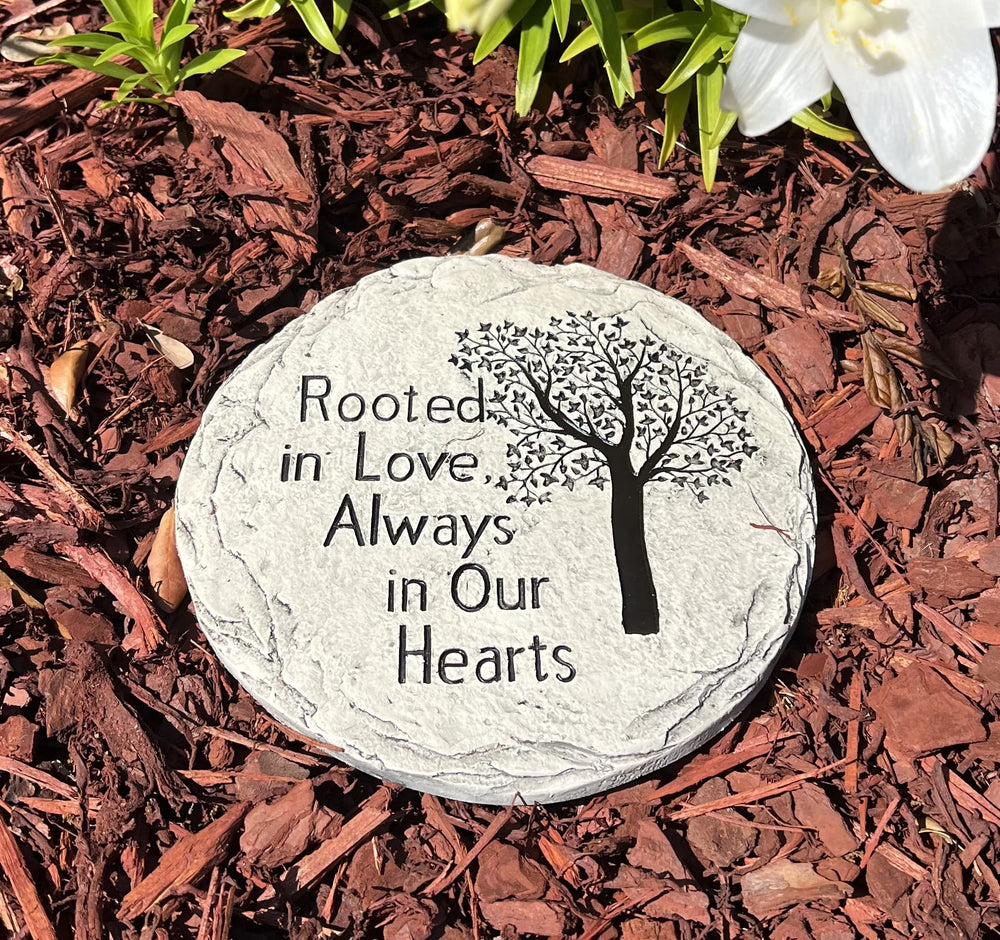 Top Brass stepping stone placed in garden near flowers demonstrating stable, respectful outdoor memorial use