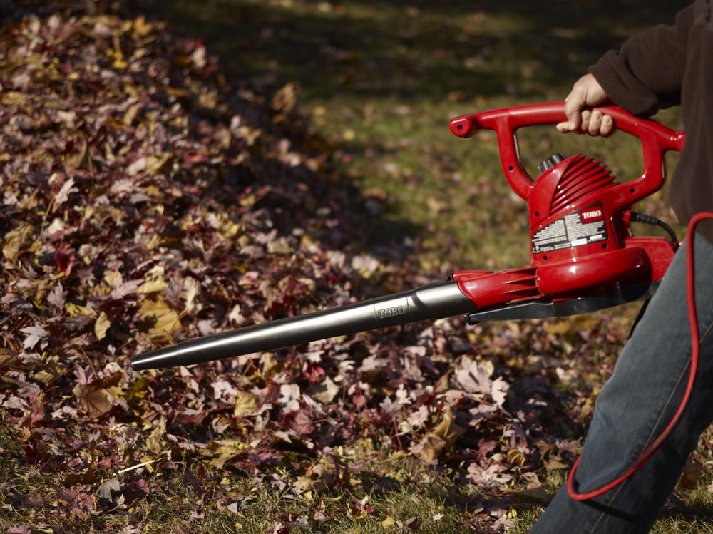 Toro blower in use on driveway clearing leaves quickly and reducing cleanup time