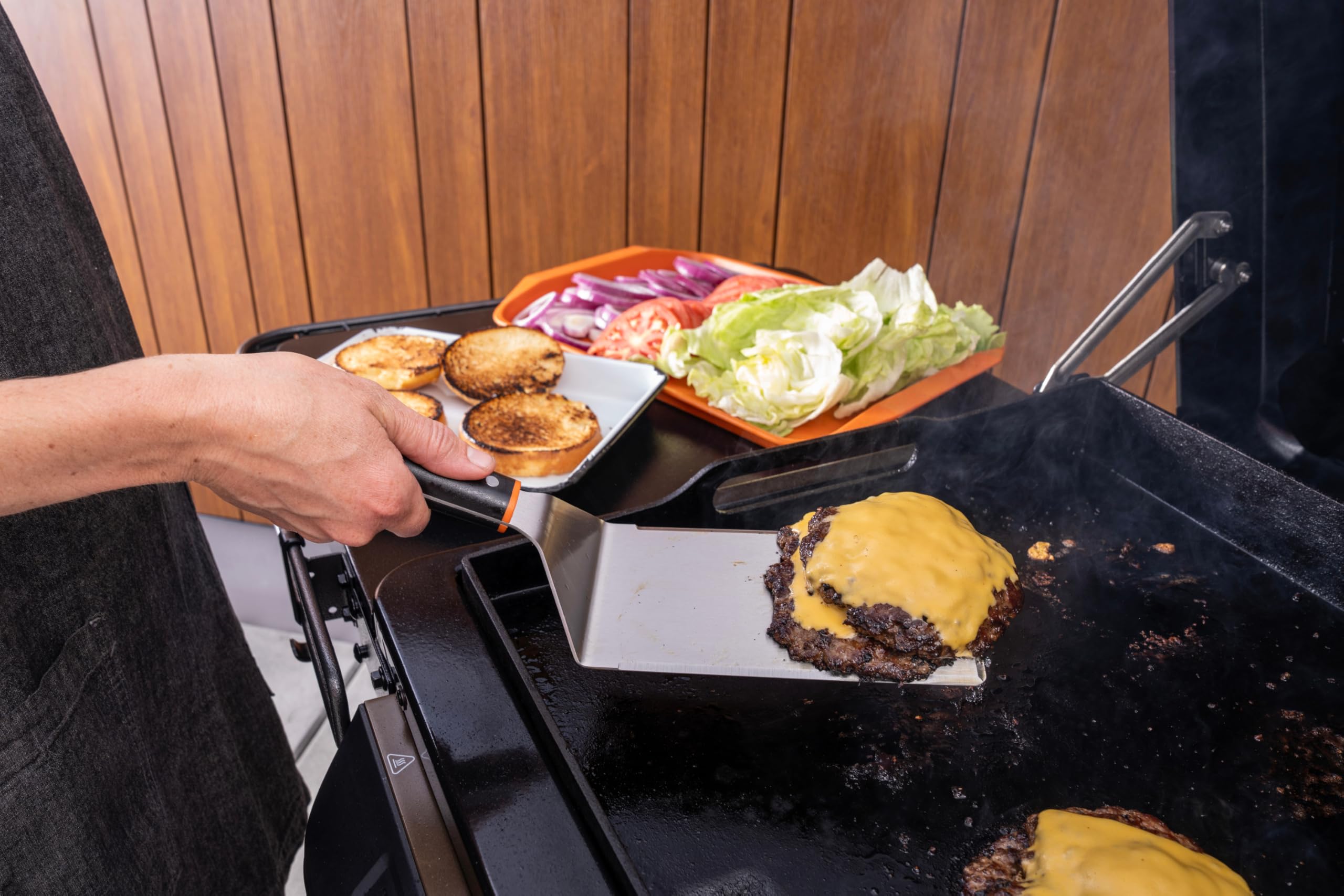 Traeger cleaning supplies beside tools demonstrating simple care and maintenance