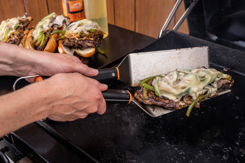 Traeger spatulas hanging on a rail for easy storage and quick access