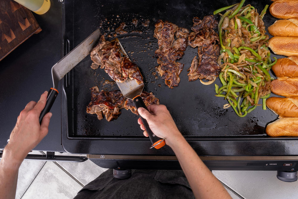 Traeger spatula serving pancakes from griddle illustrating clean lift and presentation