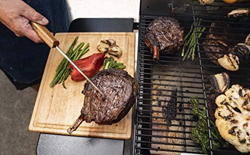 Traeger pig tail in use flipping steak to preserve sear and juices
