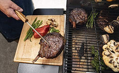 Traeger pig tail in use flipping steak to preserve sear and juices