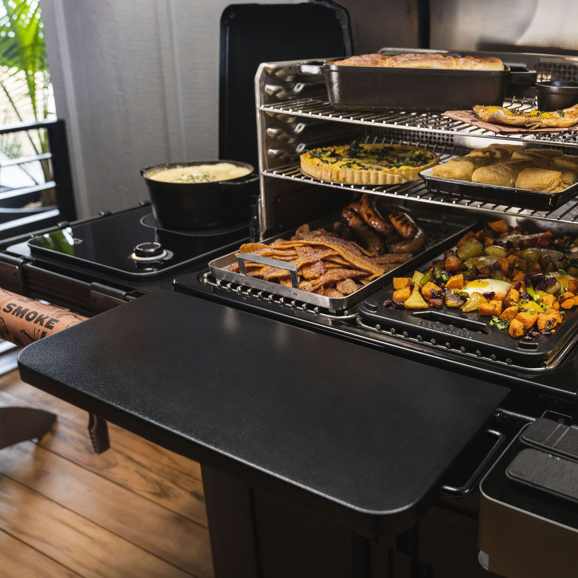 Traeger mounted shelf holding tools and plates for convenient access