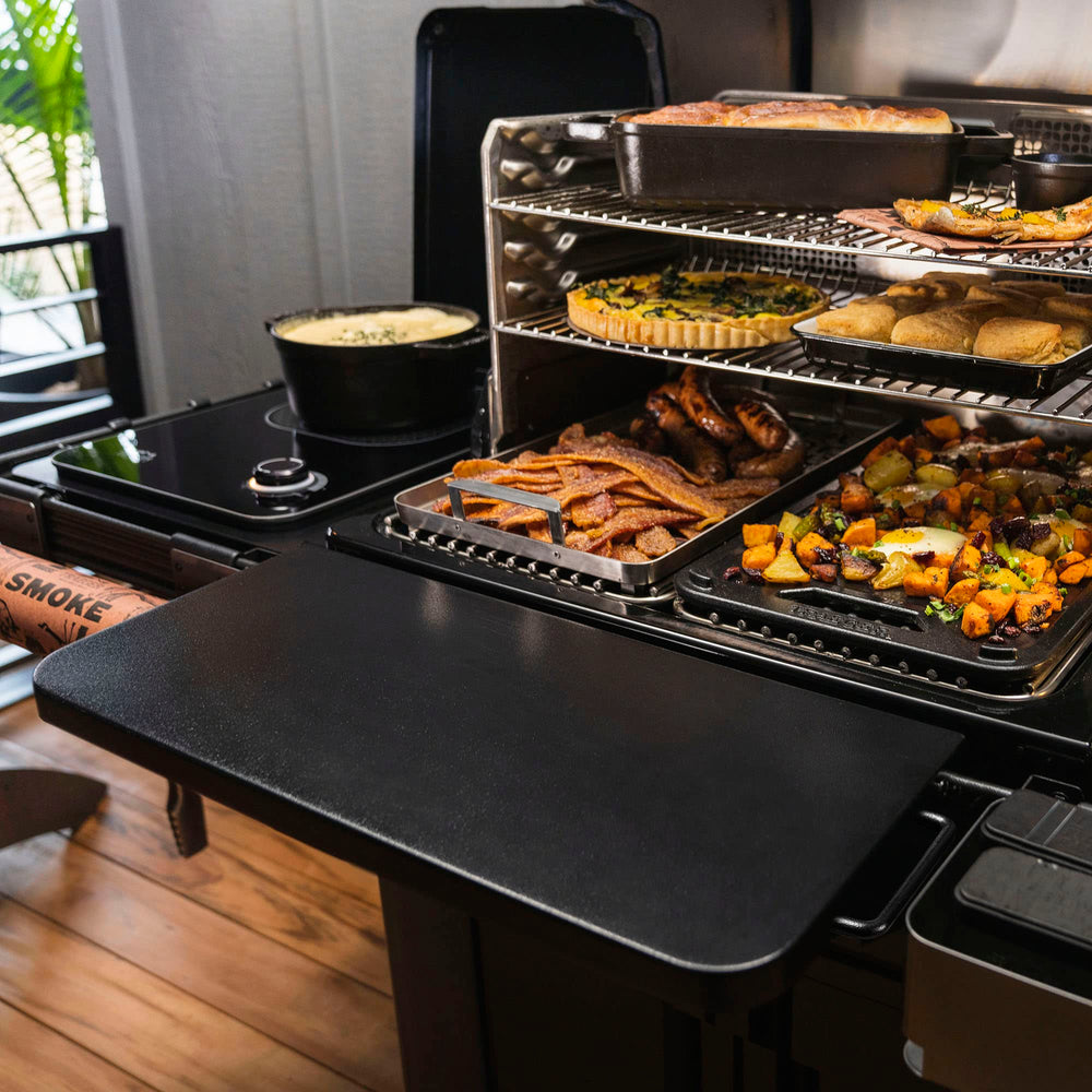 Traeger mounted shelf holding tools and plates for convenient access