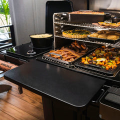 Traeger mounted shelf holding tools and plates for convenient access
