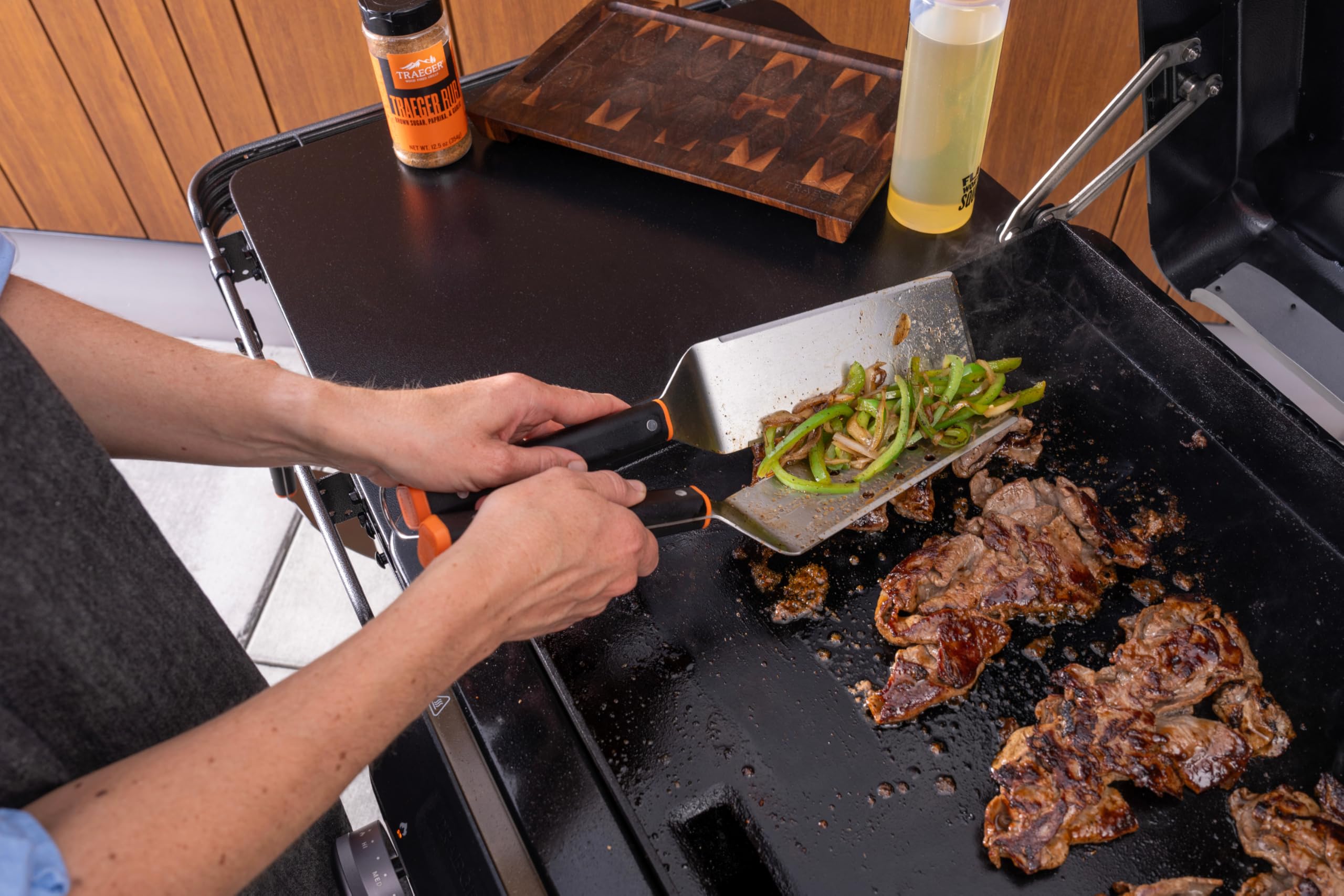 Traeger slotted spatula detail highlighting drain slots for grease control