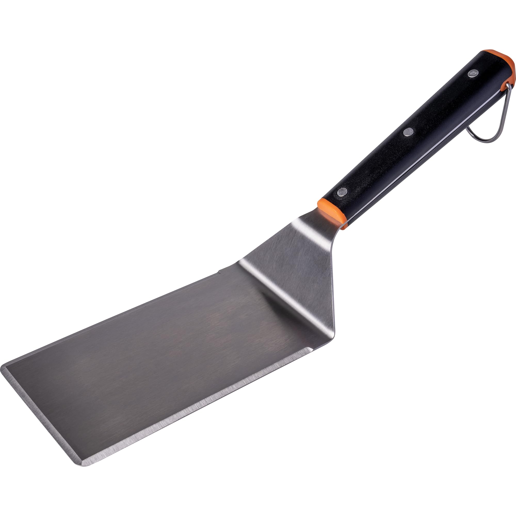 Traeger spatula and press placed on flat-top grill showing versatile cooking use