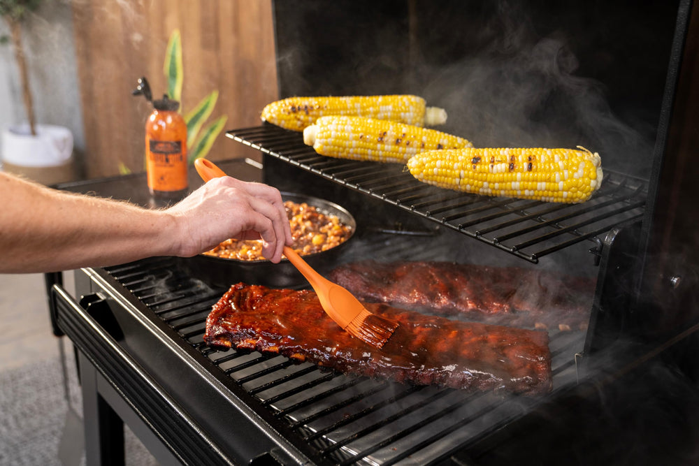 Traeger Westwood next to chair showing scale and 653 sq in cooking area