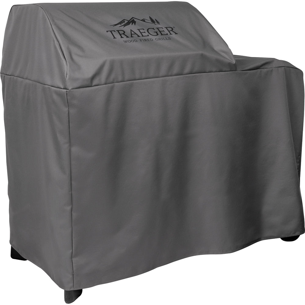 Traeger cover fitted on Woodridge grill in backyard showing element protection in use