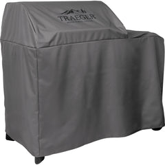 Traeger cover fitted on Woodridge grill in backyard showing element protection in use