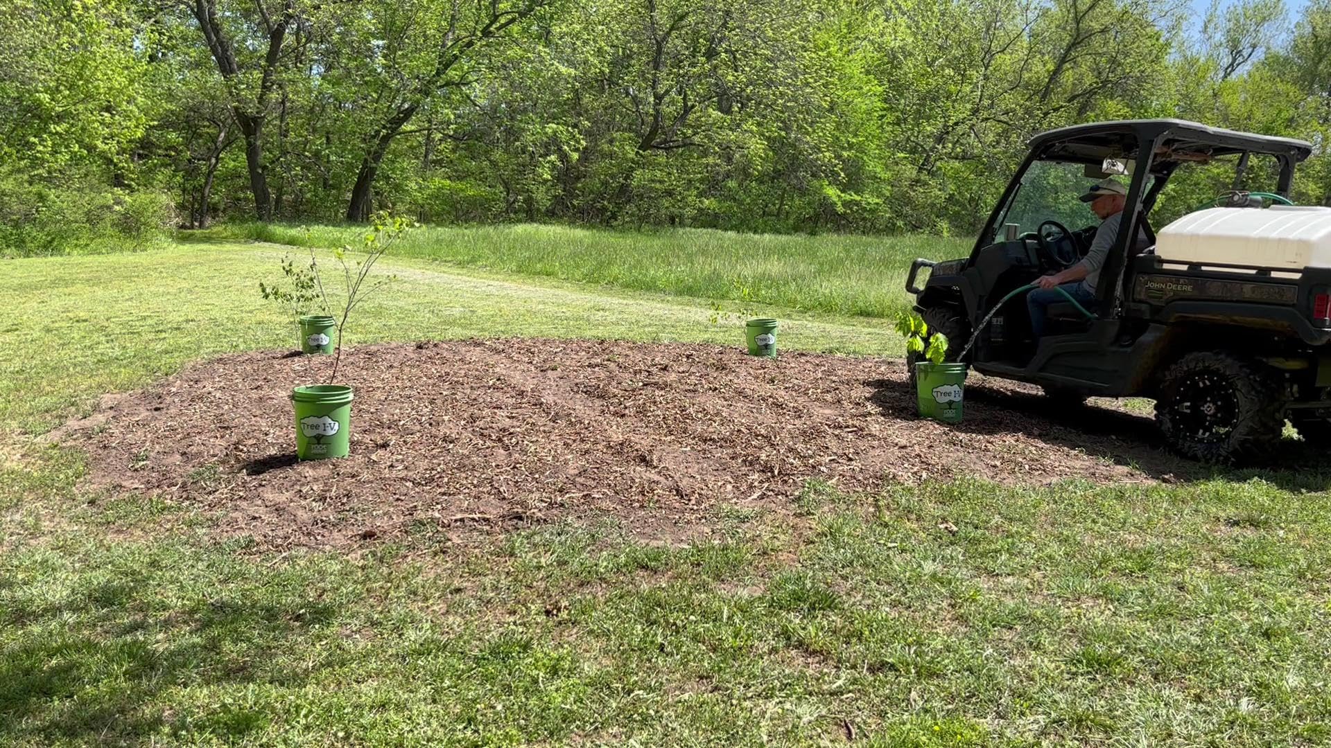 Tree I.V. reservoir beside shovel for scale, showing 5-gallon capacity advantage