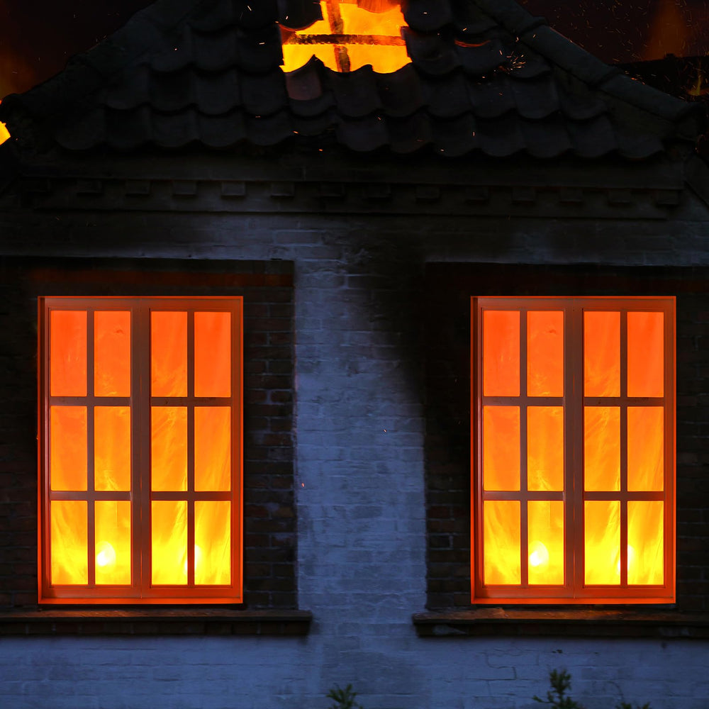 Tujoe installed window display at night creating eye-catching Halloween curb appeal
