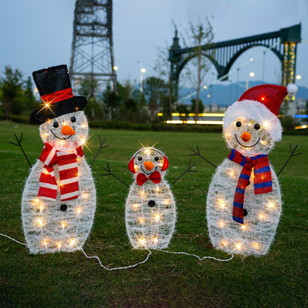 TW SHINE snowman next to garden stake showing scale and easy lawn installation