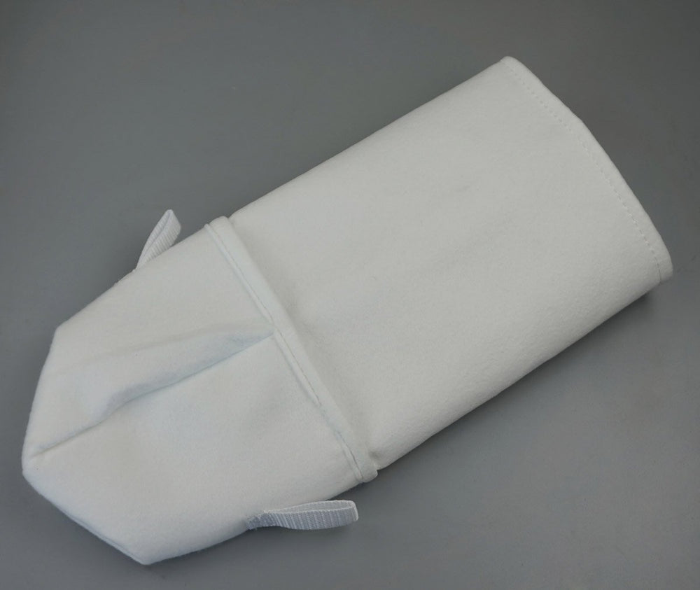 UCEDER filter bag next to hand showing scale for easy size recognition