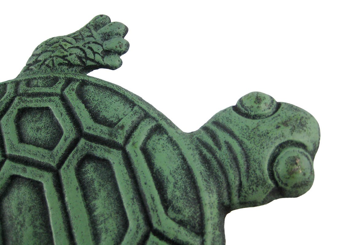 UD turtle placed among plants showing how it blends with garden beds and pathways