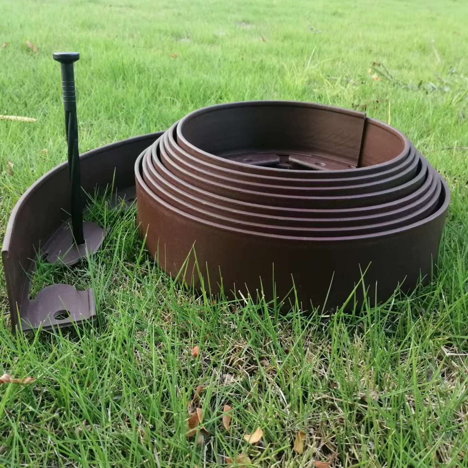 UEUORF installation shot of spiral stake driven into soil anchoring edging for stable hold