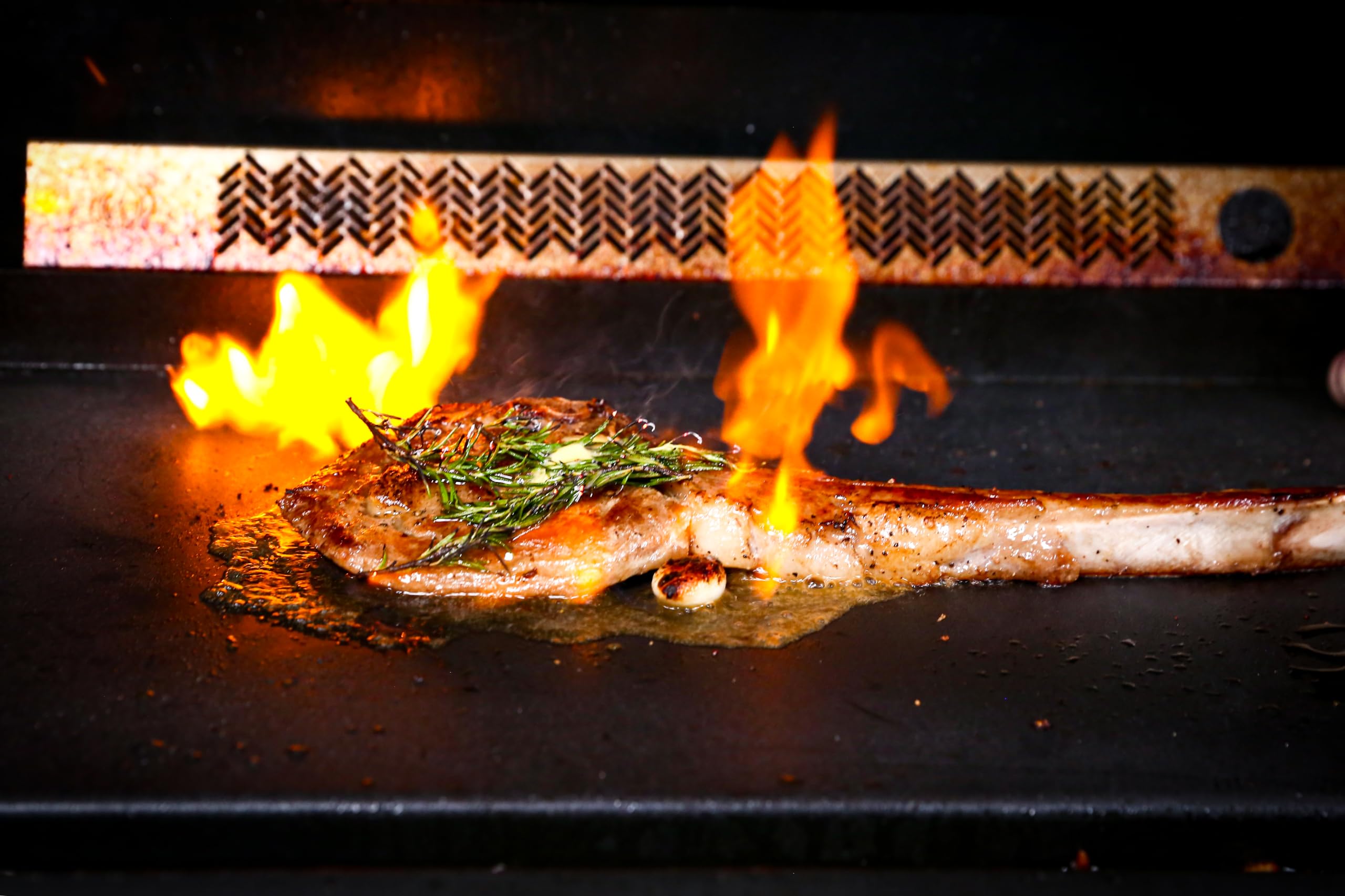 Uniflasy griddle installed in a gas grill showing even heat coverage benefit