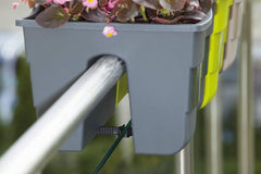 United Frames mounted on balcony rail demonstrating secure fit and space-saving benefit