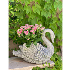 Urban Designs swan planter filled with blooms demonstrating styling benefit