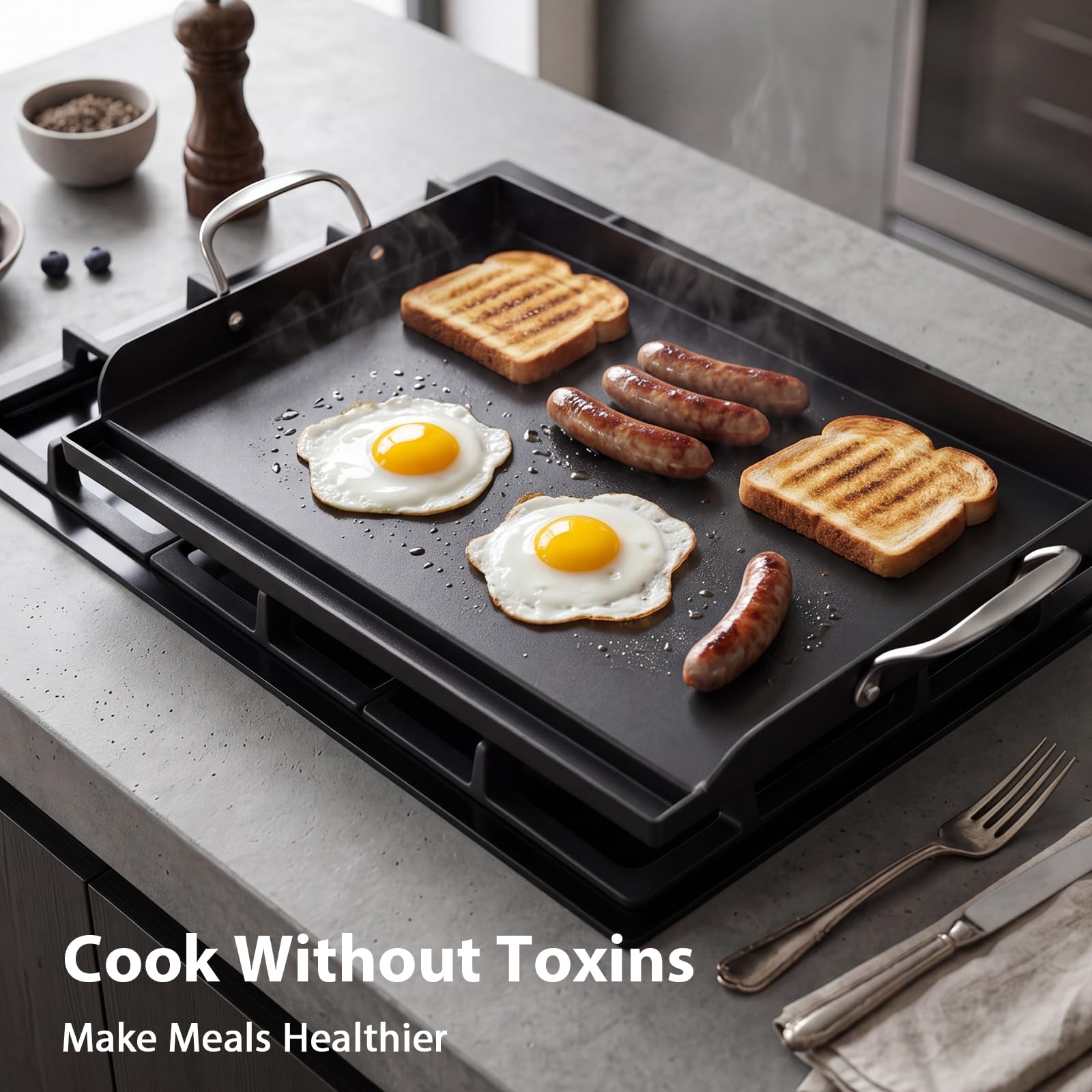 Utheer griddle next to utensils to show size and handling ease for large meals