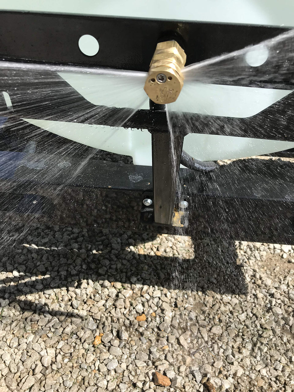 Valley Industries nozzle mounted on sprayer in field demonstrating wide 52-foot coverage