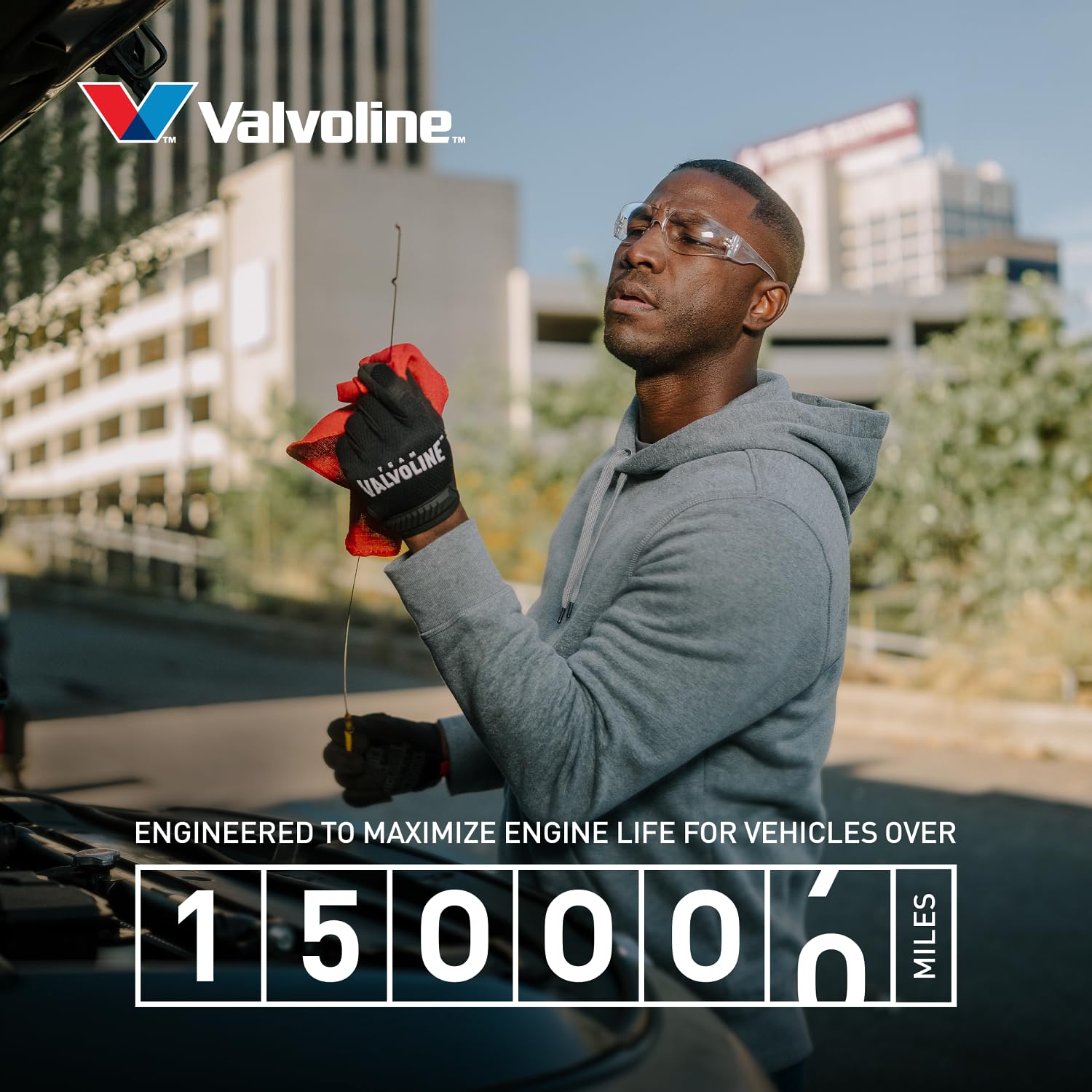Valvoline bottle being poured into engine bay to improve protection