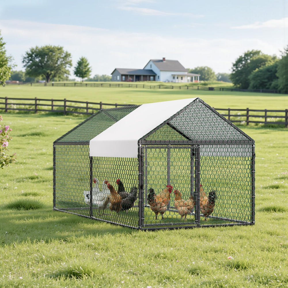 VEVOR coop beside person for scale showing compact footprint and practical size