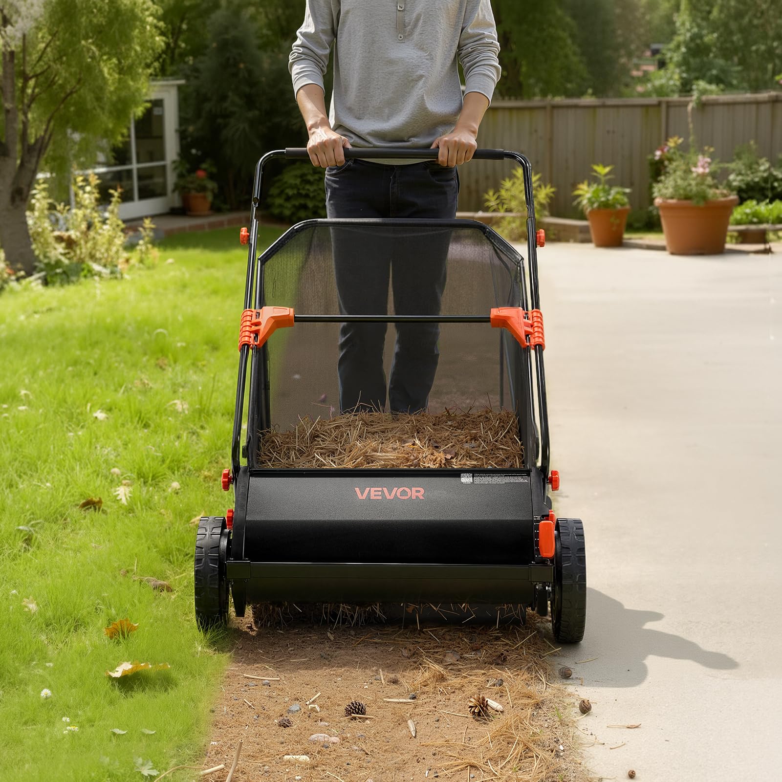 VEVOR sweeper in use on a residential lawn showing easy manual operation