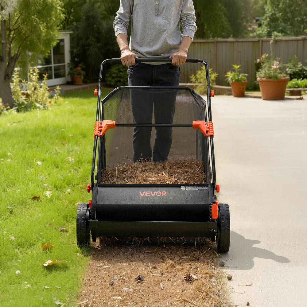 VEVOR sweeper in use on a residential lawn showing easy manual operation