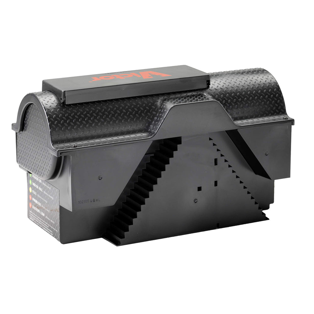 Victor trap beside hand to show size and easy placement for household use