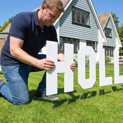 VictoryStore letters mounted on metal stakes in yard showing stable outdoor display
