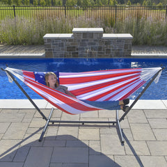 Vivere hammock in backyard lifestyle scene with two people relaxing highlighting portability and convenience
