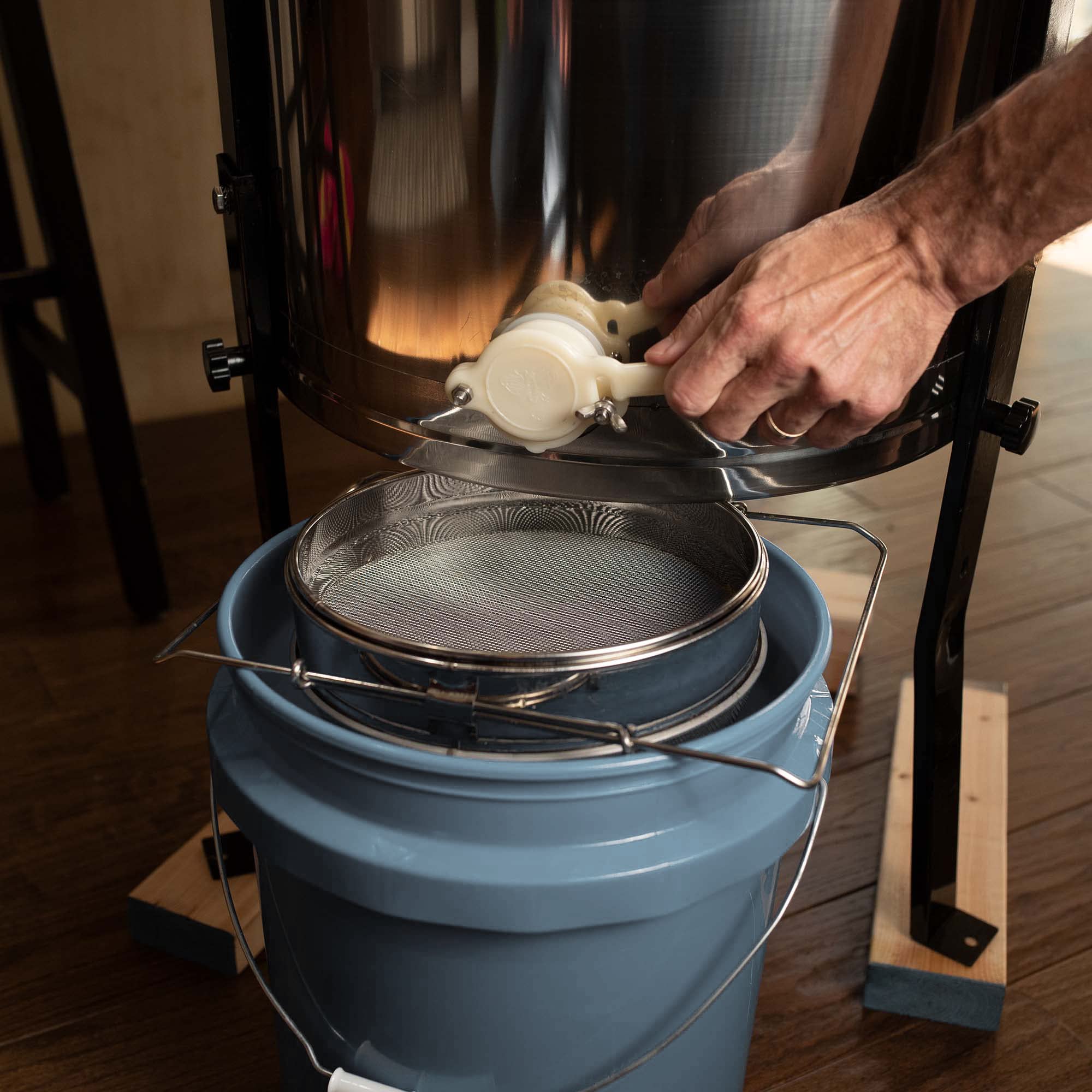 VIVO honey strainer in a kitchen scene showing practical use for small-batch bottling