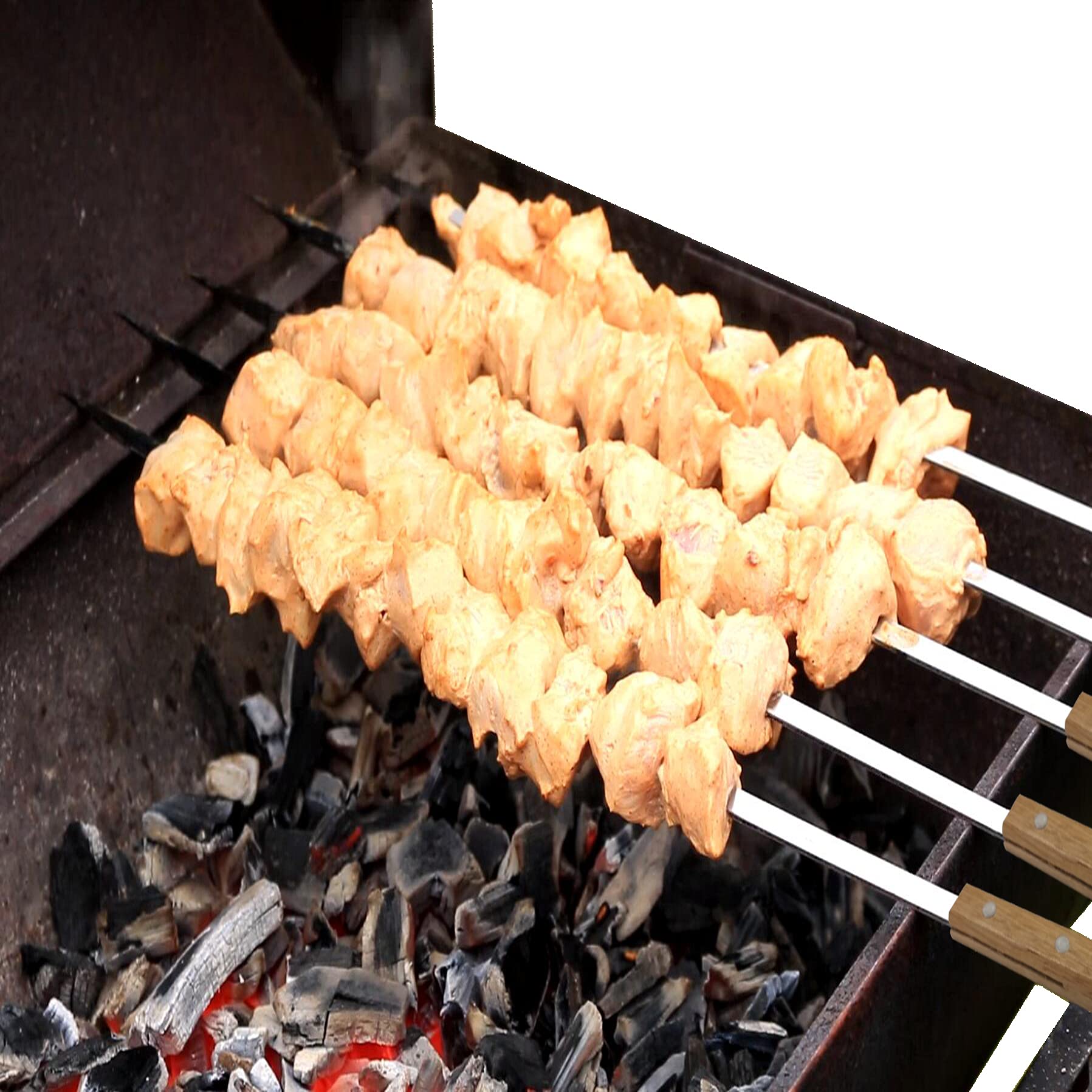 Vokop skewers cooking over charcoal for efficient heat distance