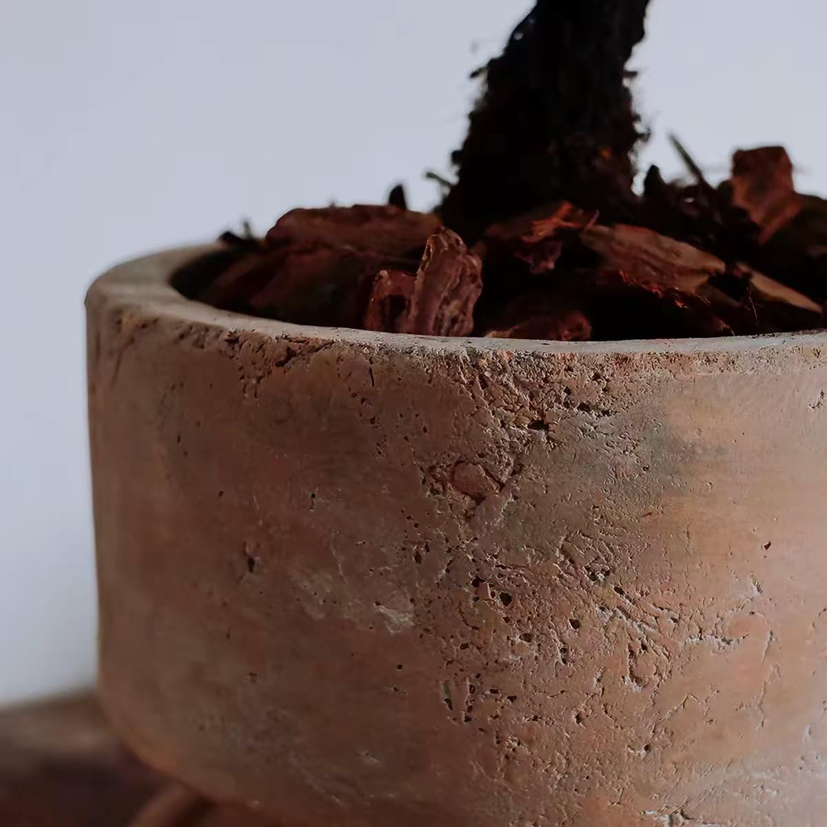 Wavy Studio pot shown next to a hand for scale, illustrating easy portability