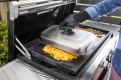 Weber basting dome in use over burgers melting cheese quickly for even, juicy results