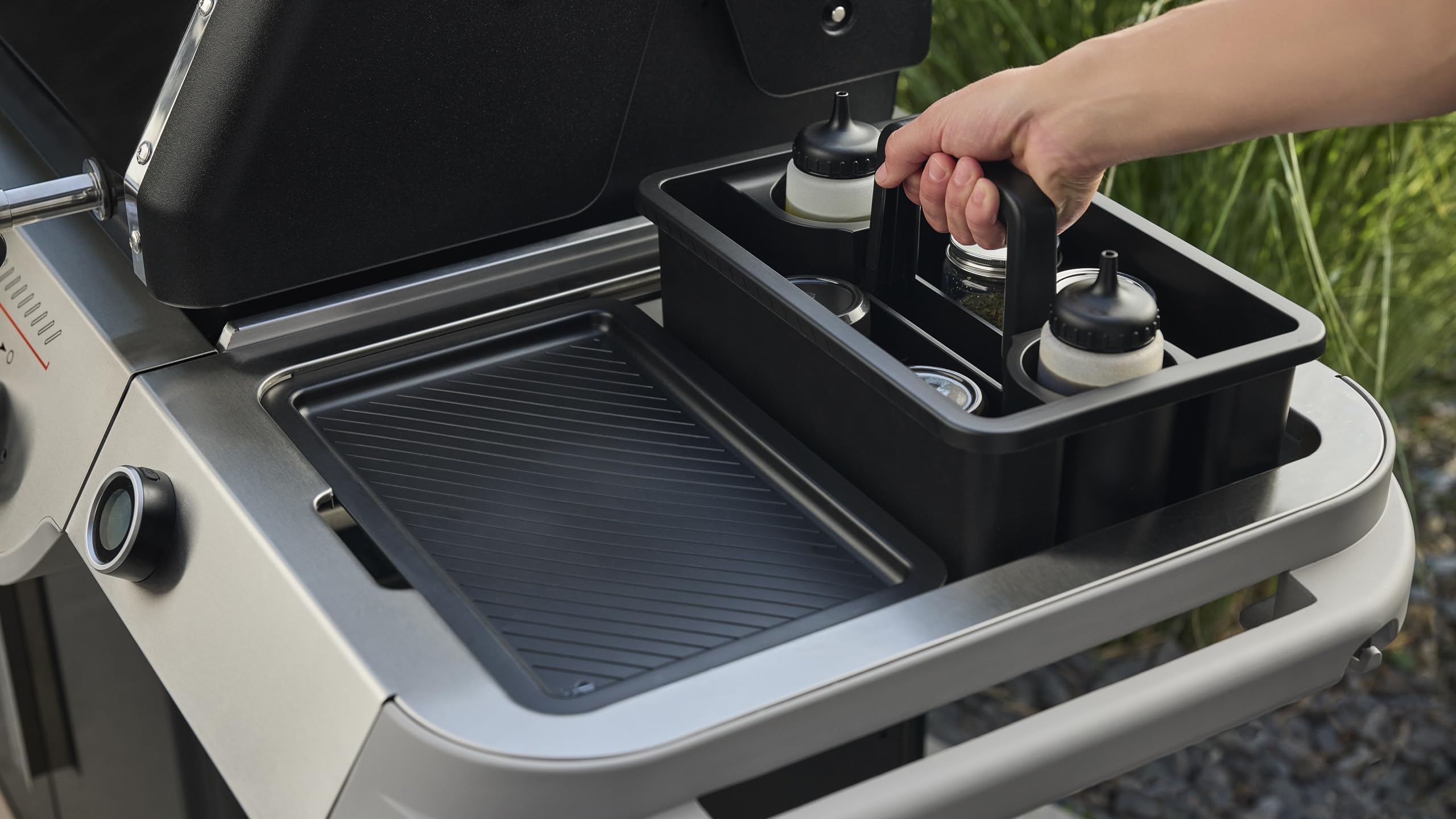 Weber caddy with handle folded for compact storage and spill-prevention benefit