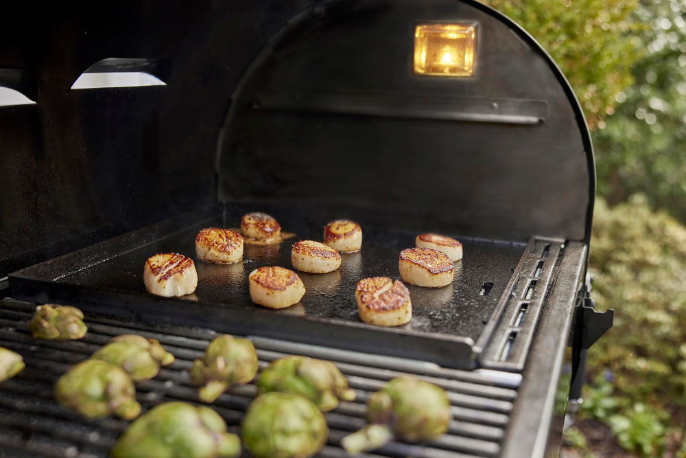 Weber Crafted griddle beside sear grate showing dual-cooking versatility benefit