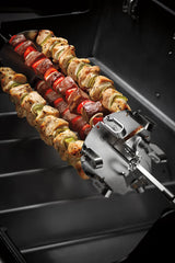 Weber crafted skewers mounted on rotisserie spit showing even rotation benefit