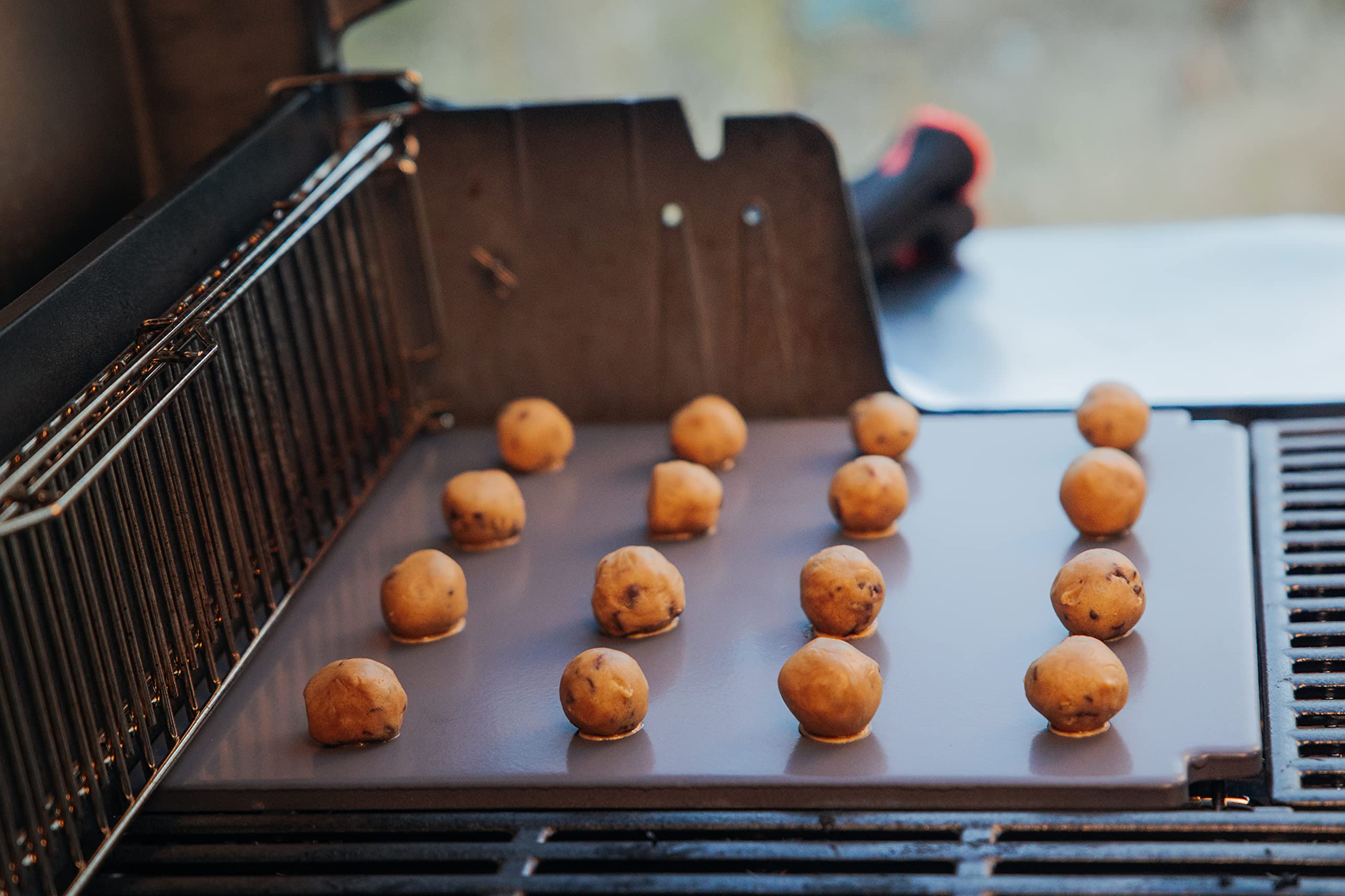 Weber crafted in-use shot of stone in grill delivering high-heat baking performance