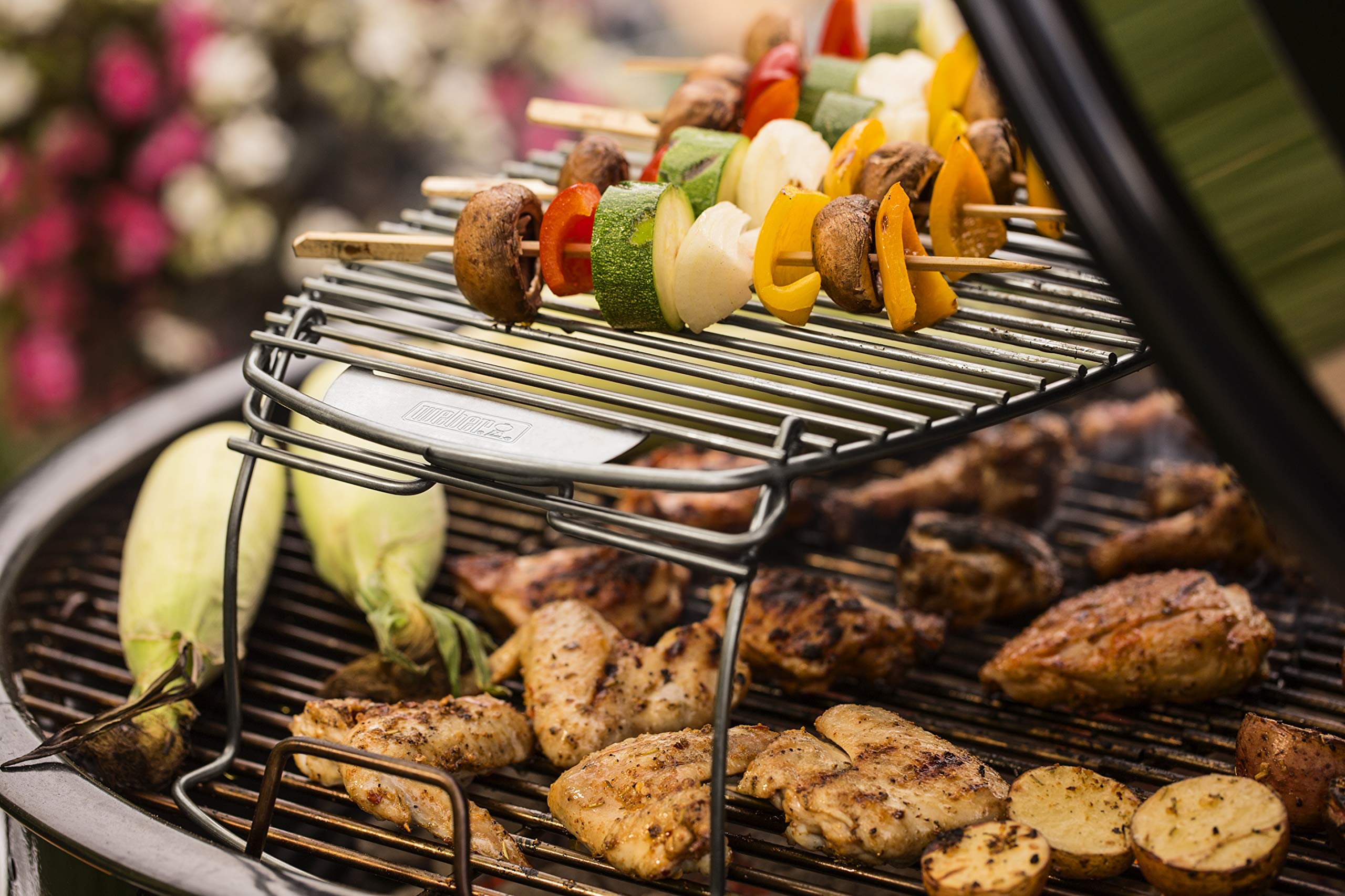 Weber rack in backyard grill scene ready for entertaining with more food