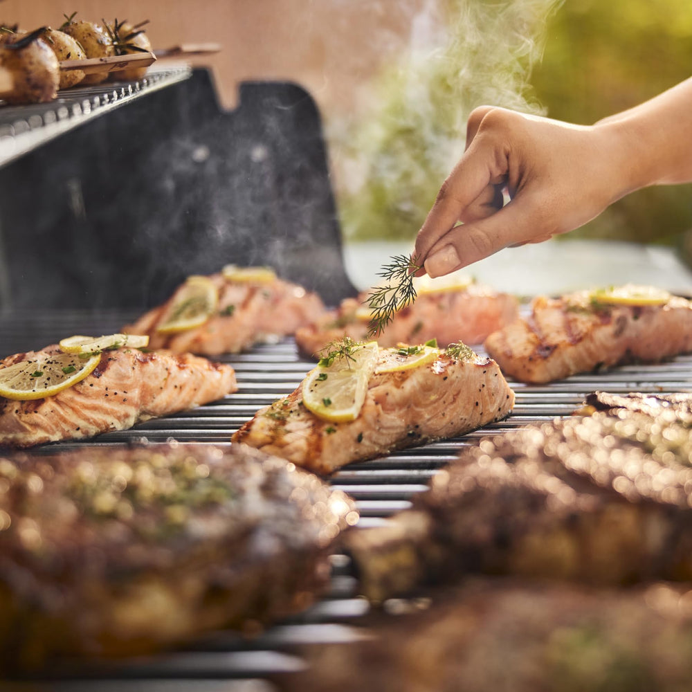 Weber Genesis S-315 in backyard lifestyle scene enabling group grilling and entertaining