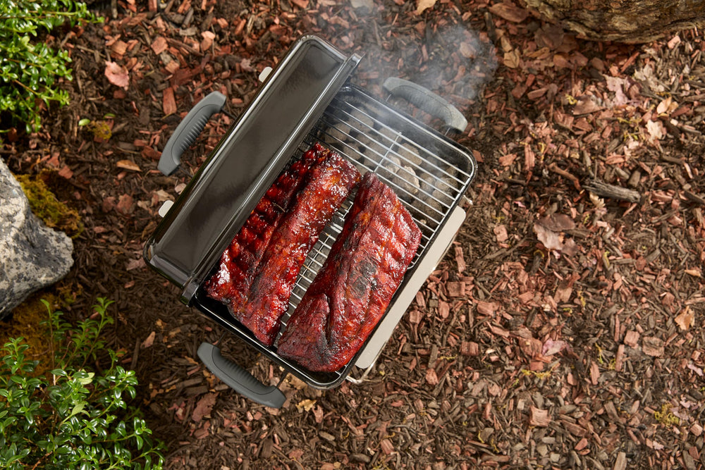 Weber grill shown fitting in car boot illustrating portability and easy transport
