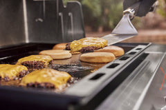 Weber griddle cooking pancakes and eggs for quick versatile outdoor breakfasts
